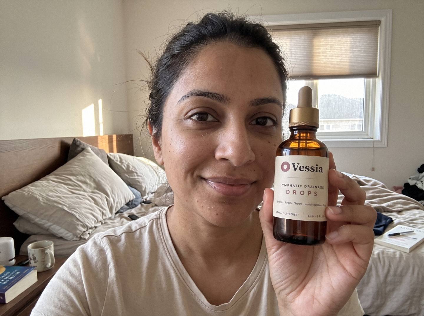 Priya S. holding Vessia Lymphatic Drainage Drops